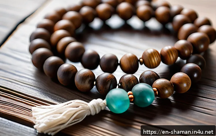 무속 관련 기념품 - A serene close-up of a handcrafted wooden mala bead necklace resting gently on a rustic wooden table...